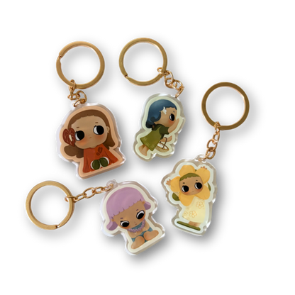 Set of four keychains with cartoon character figures on a white background