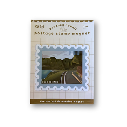A postage stamp magnet product shown in its retail packaging on a plain white background. The package reads 'Hanananahawaii postage stamp magnet' and features a sample stamp design with a road through green hills under a blue sky.
