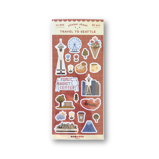 A sheet of travel-themed stickers featuring Seattle landmarks and icons, including the Space Needle, Pike Market, and a coffee cup, on a red brick patterned background with a cream border.
