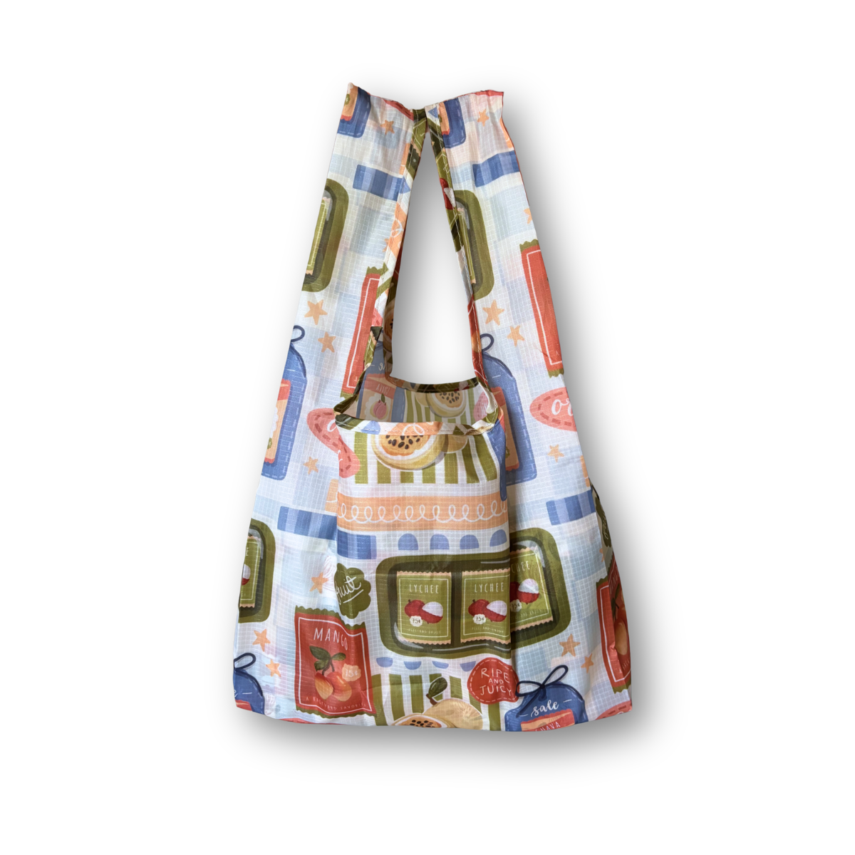 A reusable fabric tote bag with a colorful vintage-style storefront pattern, featuring light blue, green, red, and orange details on a white background.
