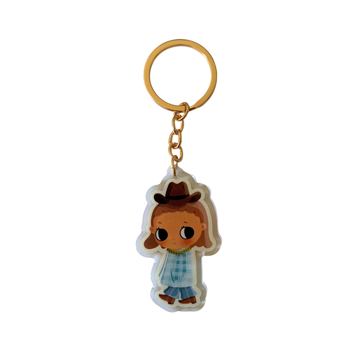 A cartoon-style acrylic keychain featuring a character with brown hair, a brown hat, a blue plaid shirt, and blue pants, attached to a gold metal key ring and chain on a white background.