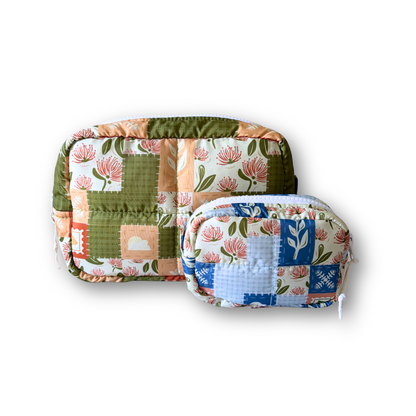 Two quilted patchwork cosmetic pouches with floral and geometric prints, displayed on a clean white background.