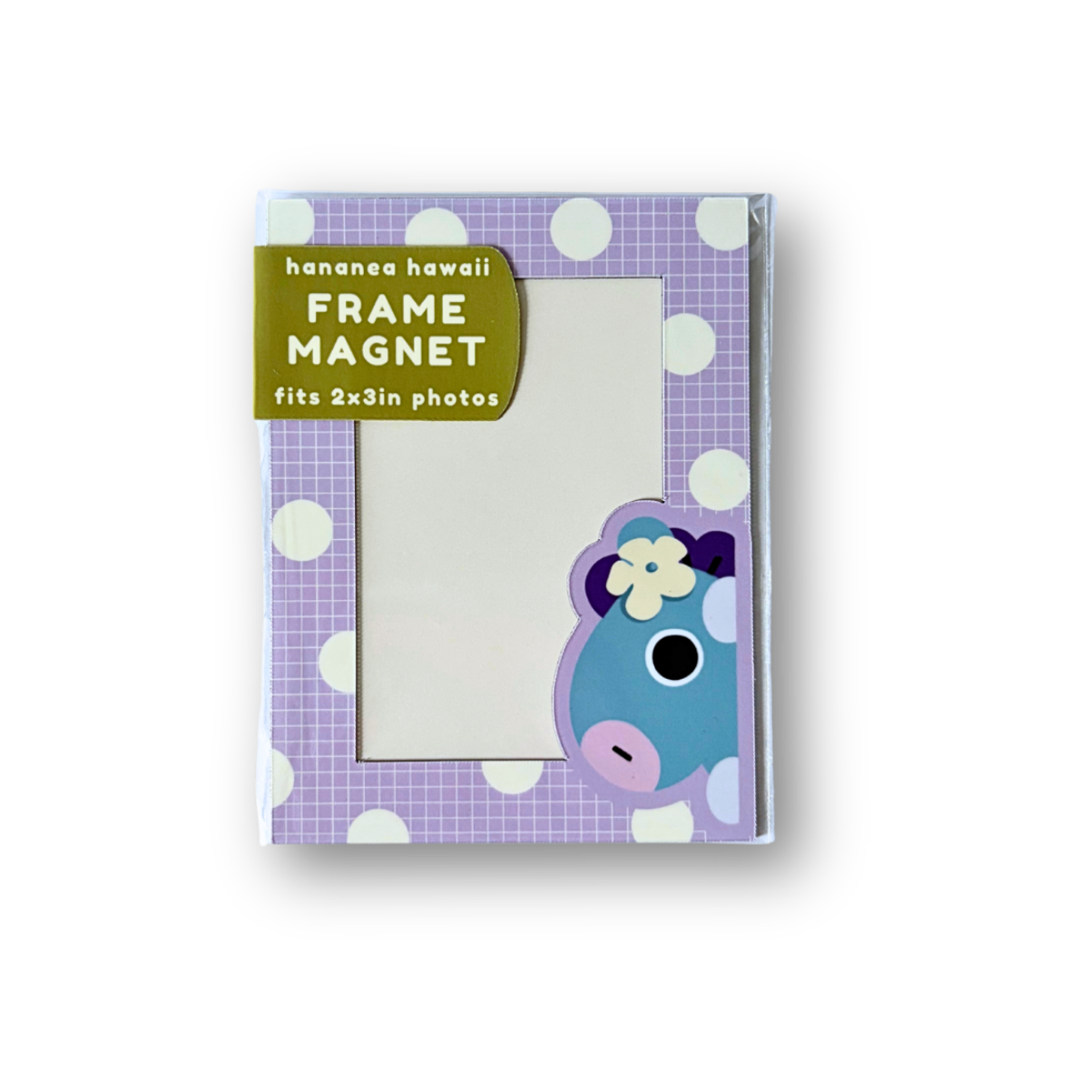A frame magnet shown in its packaging against a white background. The magnet features a purple and white checkered pattern with white polka dots, a green label, and a blue cartoon character wearing a flower.
