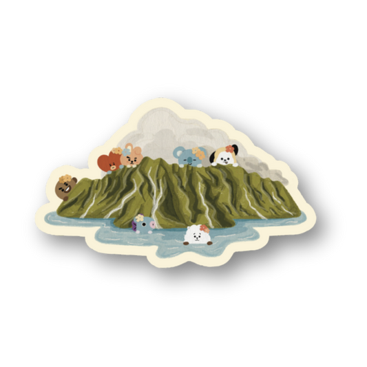 A die-cut sticker featuring a whimsical illustration of a green mountain with cartoon animals and a small waterfall, shown on a plain white background.