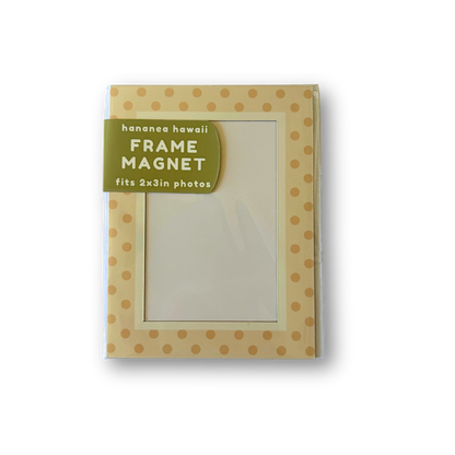 A rectangular picture frame magnet featuring a tan and yellow polka dot pattern with a green label on the top left, shown on a white background.