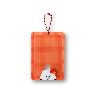 An orange rectangular plastic card holder or pouch with a red hanging loop, featuring a small white cartoon dog character with a red bow at the bottom, shown on a plain white background.