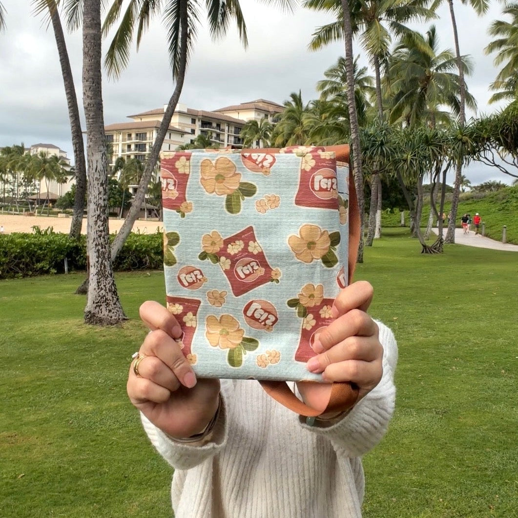 Person holding a product with palm trees in the background