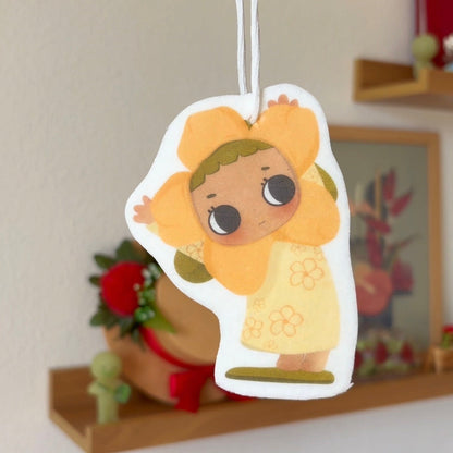 Cartoon character air freshener hanging against a neutral background