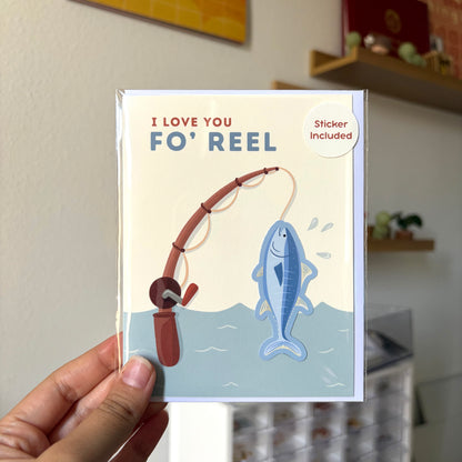 Card with fishing illustration and text 'I Love You Fo' Reel' held by a hand.