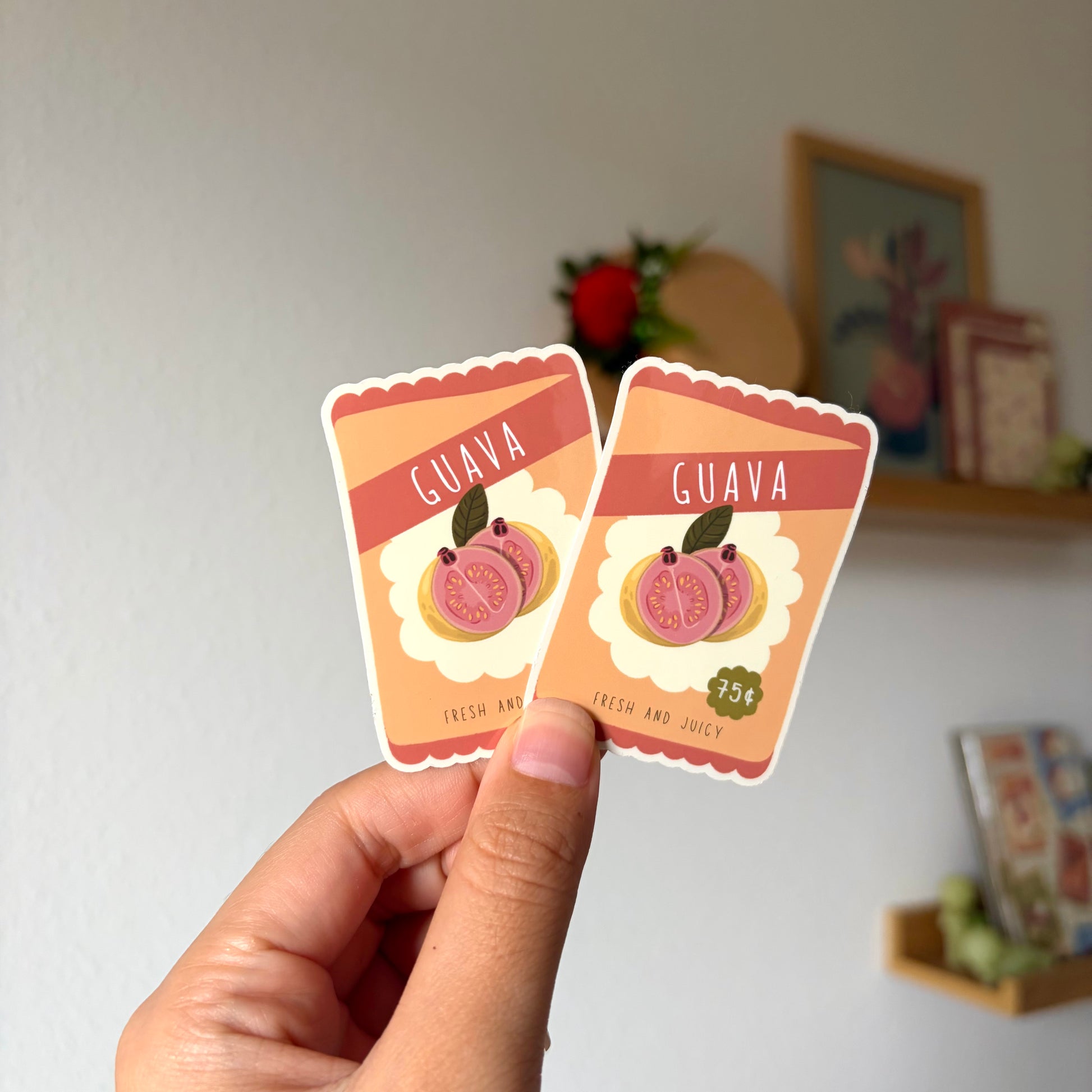 Two small card-like items with 'Guava' text held by a hand against a neutral background.